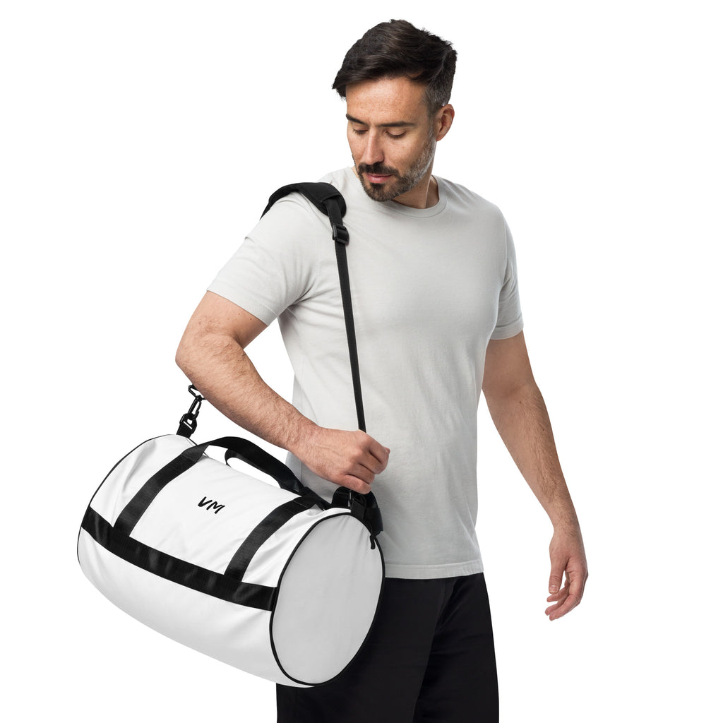 VM Spacial Version Gym Bag Ready to get your fitness on? Add some punch to pumping iron with this all-over print gym bag. Made from 100% polyester and sturdy, water-resistant fabric, this bag is fun meets function. And it’s got pockets! • 100% polyester •