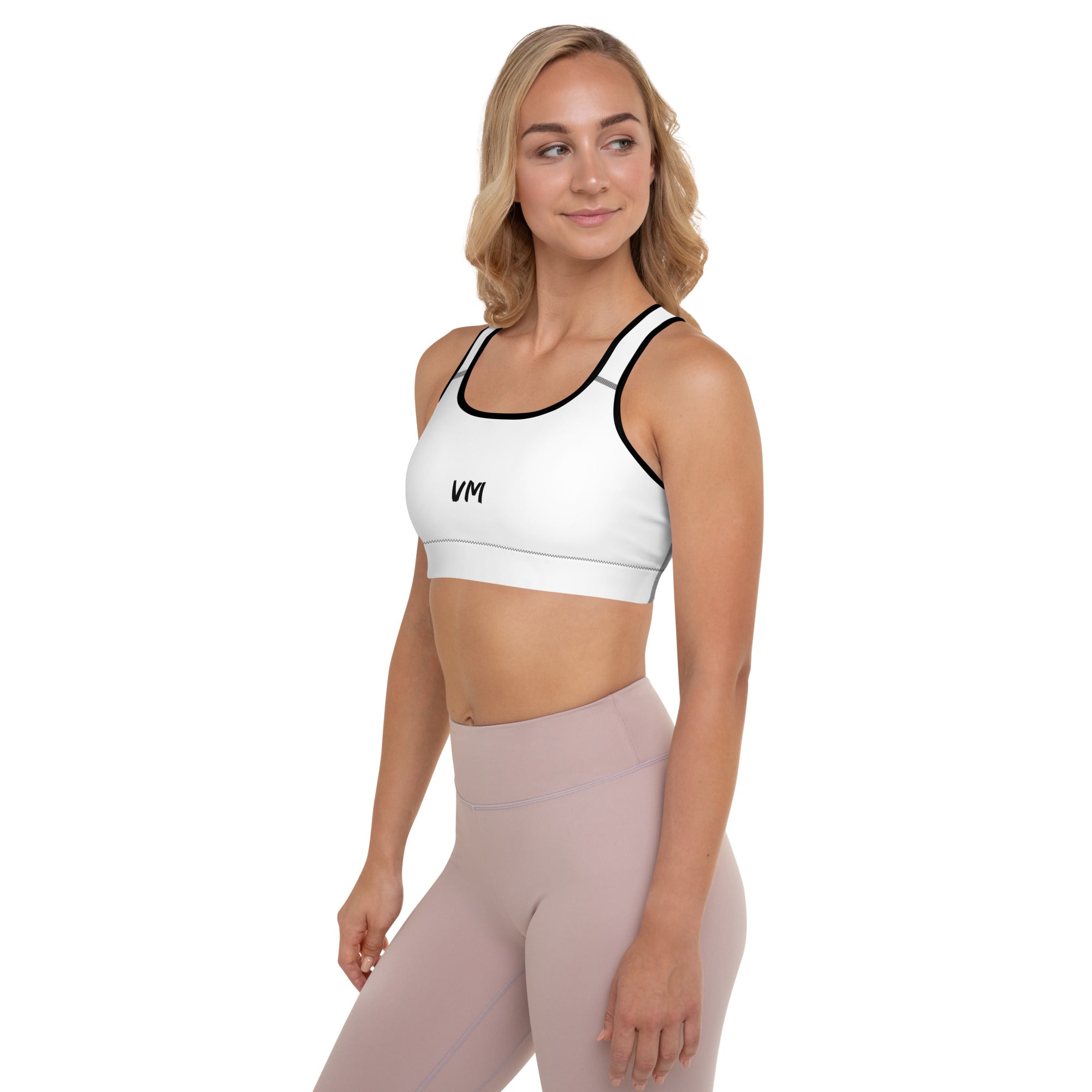 VM's Padded Sports Bra Get the perfect bra for your workouts! This comfy bra has a soft moisture-wicking fabric, extra materials in shoulder straps, and removable padding for maximum support. • 75% recycled polyester, 25% elastane for production in the US