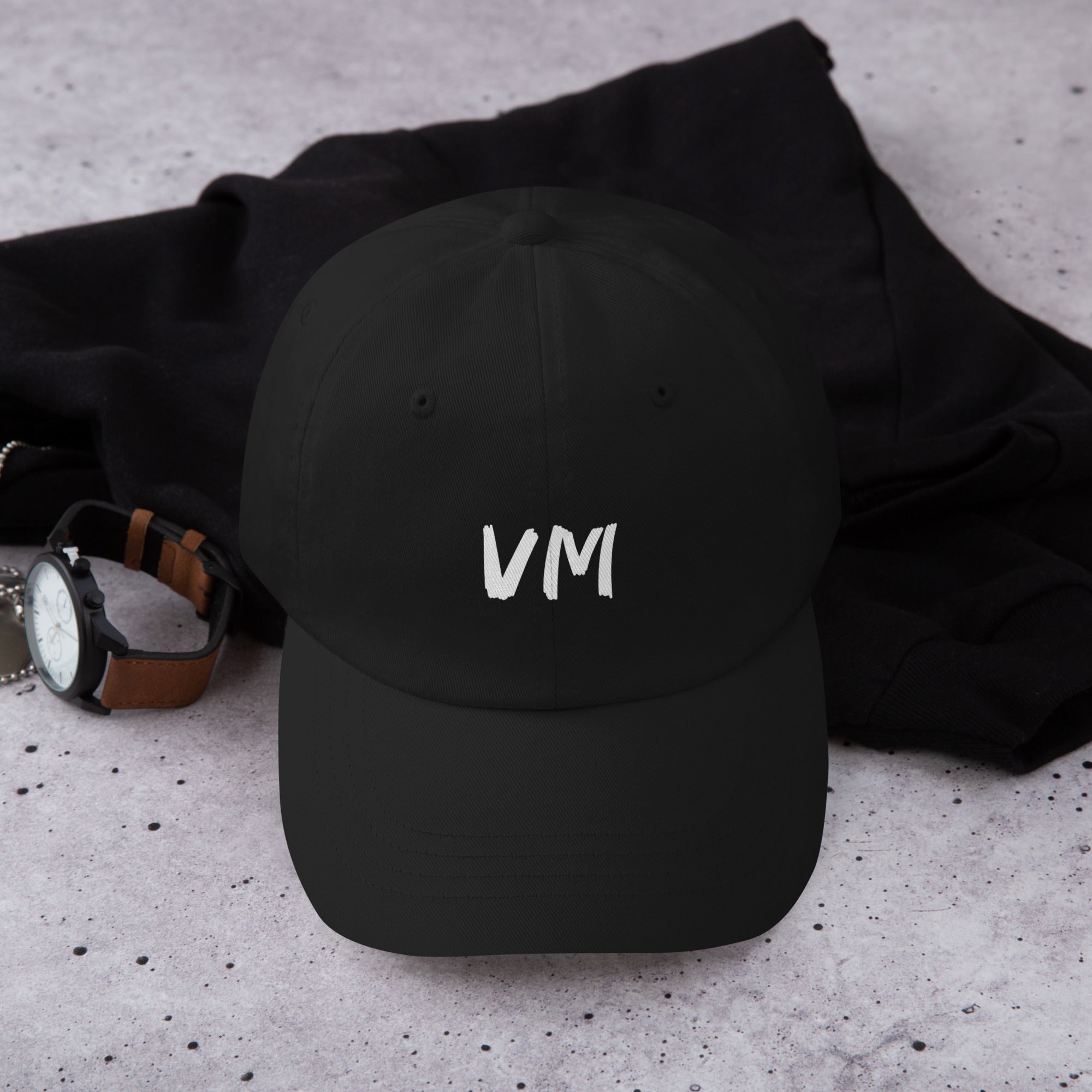 VM OFFICIAL HAT VM hats aren't just for everyone. This one's got a low profile with an adjustable strap and curved visor. • 100% chino cotton twill • Green Camo color is 35% chino cotton twill, 65% polyester • Unstructured, 6-panel, low-profile • 6 embroi