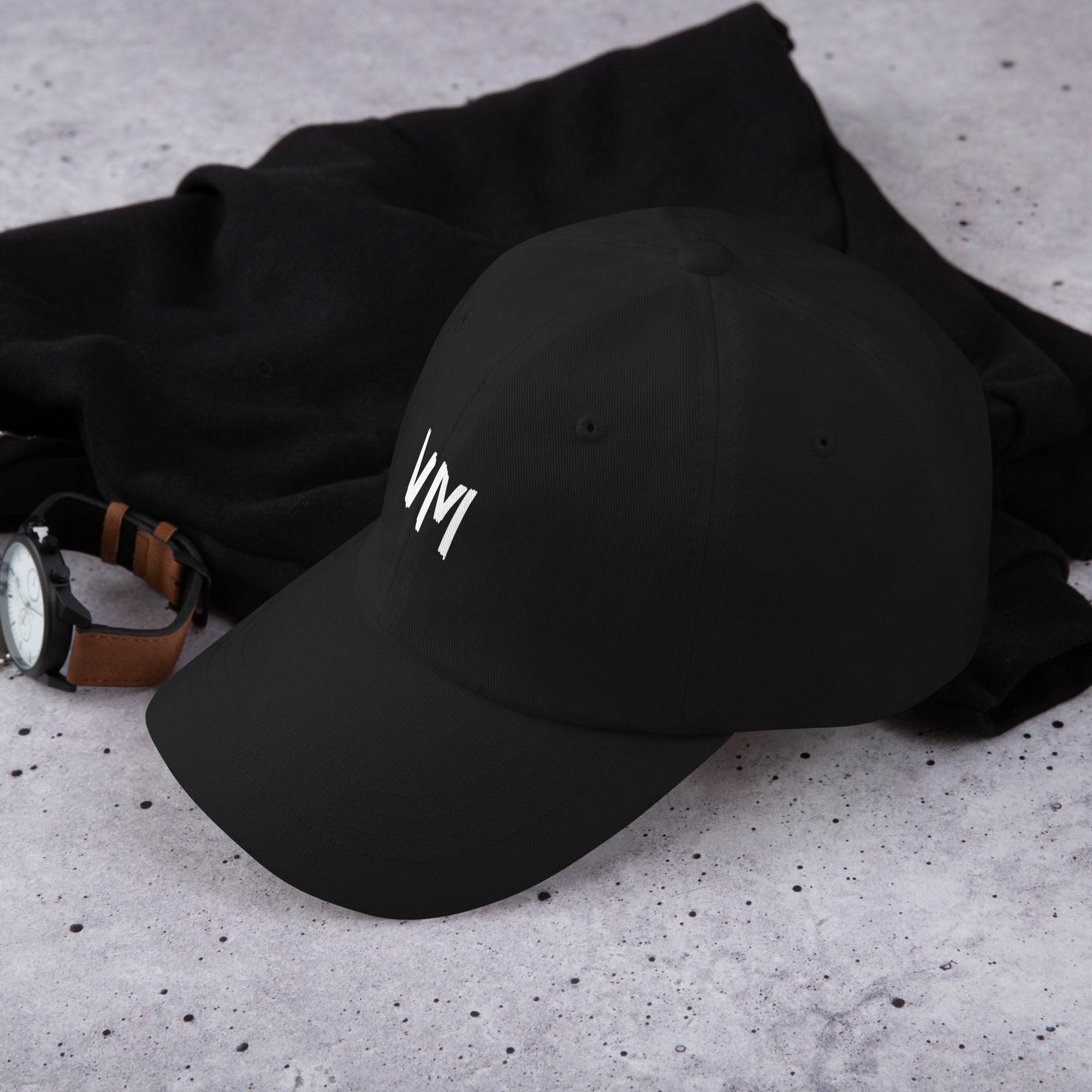 VM OFFICIAL HAT VM hats aren't just for everyone. This one's got a low profile with an adjustable strap and curved visor. • 100% chino cotton twill • Green Camo color is 35% chino cotton twill, 65% polyester • Unstructured, 6-panel, low-profile • 6 embroi