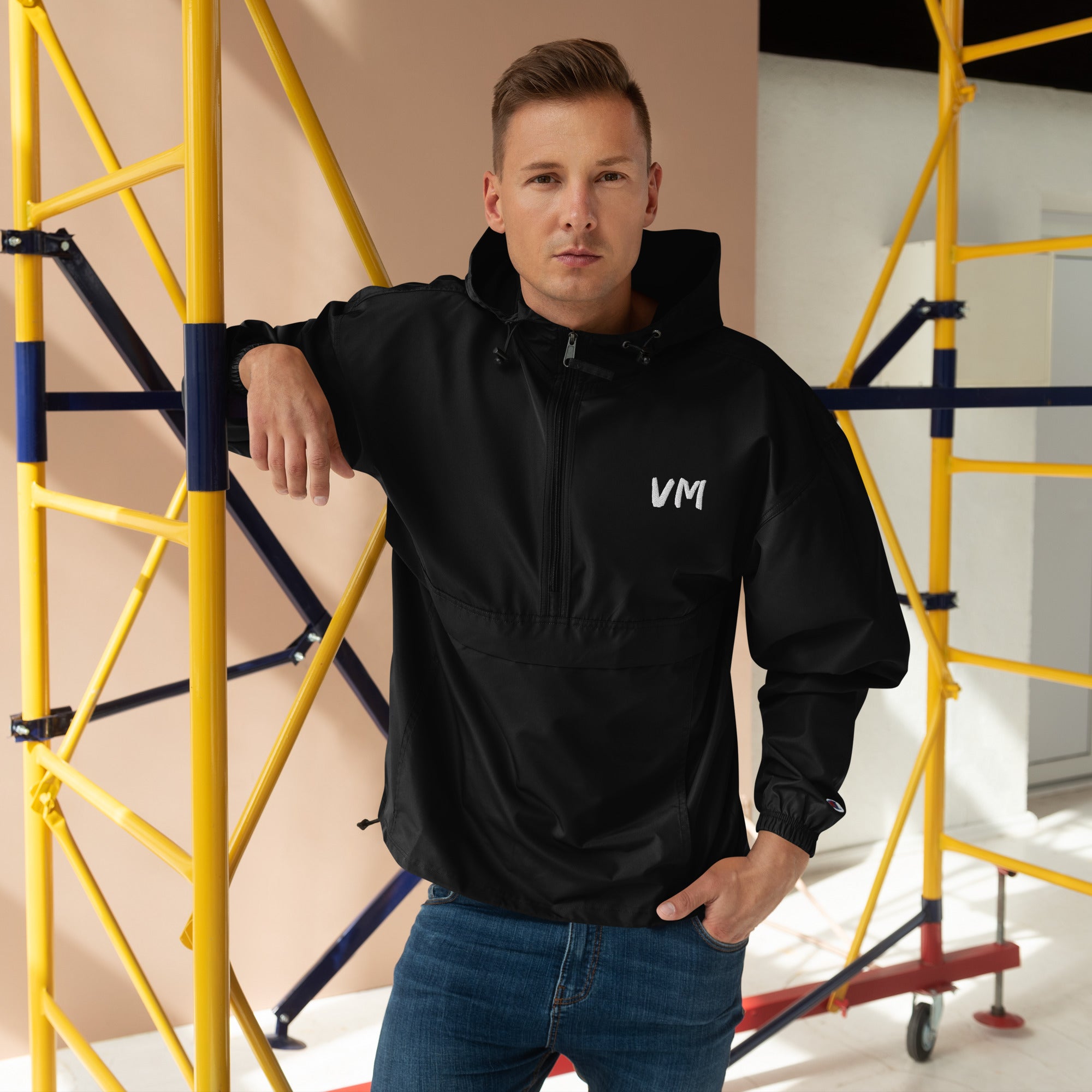 VM Official Embroidered Champion Packable Jacket Protect yourself from the elements with this Champion packable jacket. This wind and rain resistant polyester jacket with a detailed embroidery design has a practical hood, front kangaroo pocket, and zipped