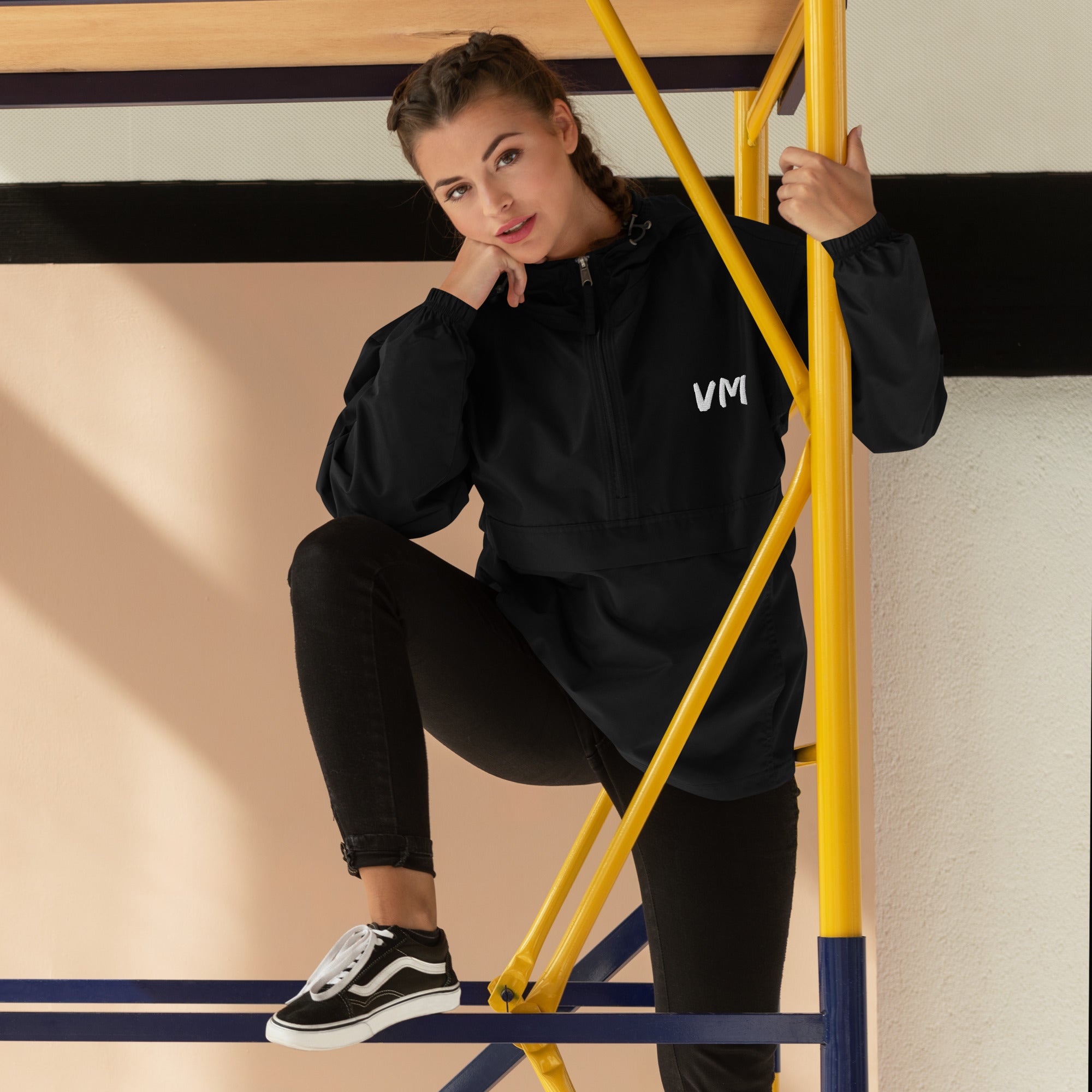 VM Official Embroidered Champion Packable Jacket Protect yourself from the elements with this Champion packable jacket. This wind and rain resistant polyester jacket with a detailed embroidery design has a practical hood, front kangaroo pocket, and zipped