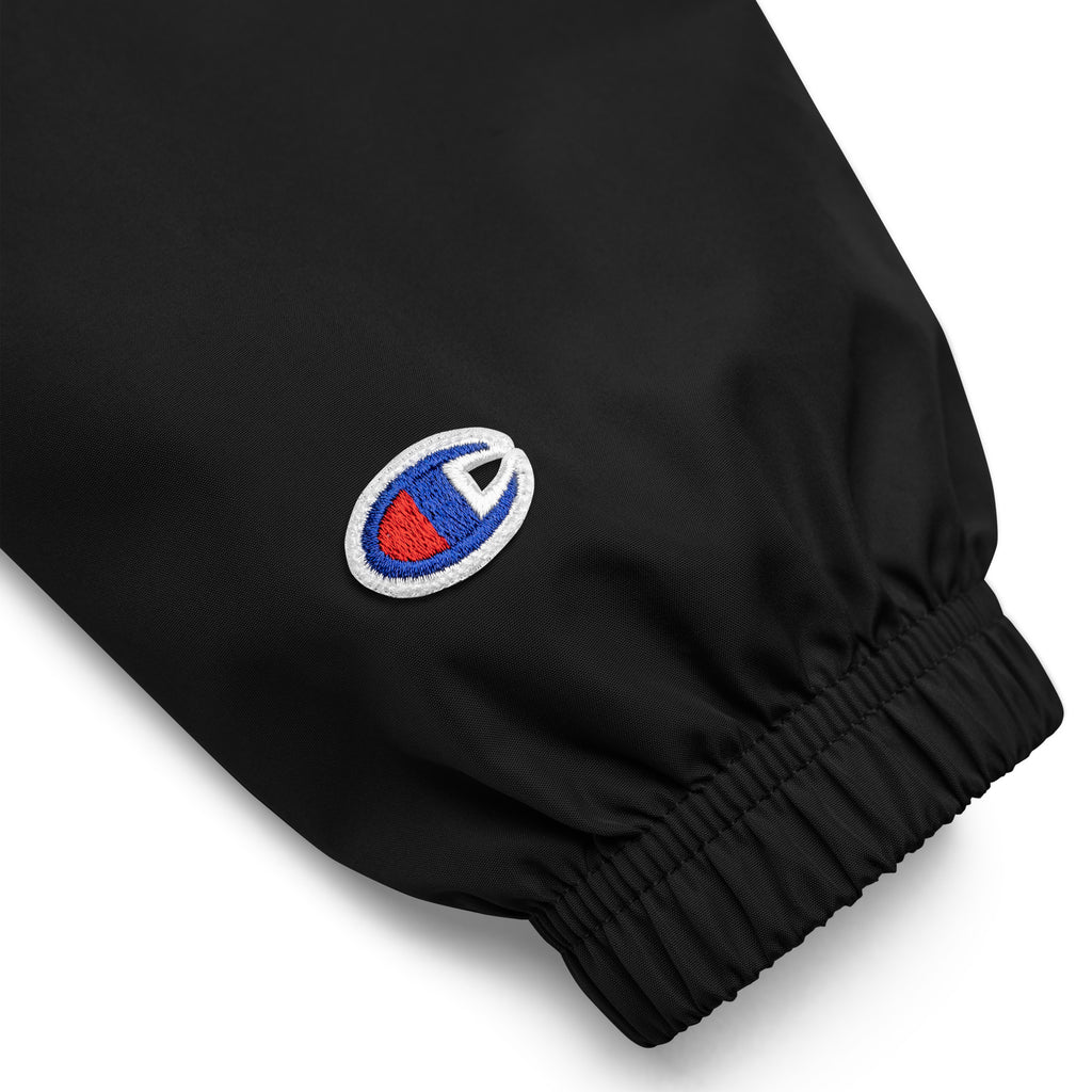 VM Official Embroidered Champion Packable Jacket Protect yourself from the elements with this Champion packable jacket. This wind and rain resistant polyester jacket with a detailed embroidery design has a practical hood, front kangaroo pocket, and zipped