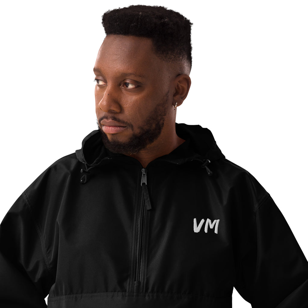 VM Official Embroidered Champion Packable Jacket Protect yourself from the elements with this Champion packable jacket. This wind and rain resistant polyester jacket with a detailed embroidery design has a practical hood, front kangaroo pocket, and zipped
